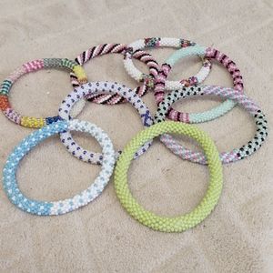 Eight handmade beaded bracelets.